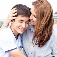 Picture of a christian woman hugging a teenage boy