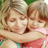 Picture of a christian woman hugging a young girl