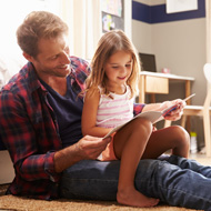 Picture of a christian man reading to a young girl